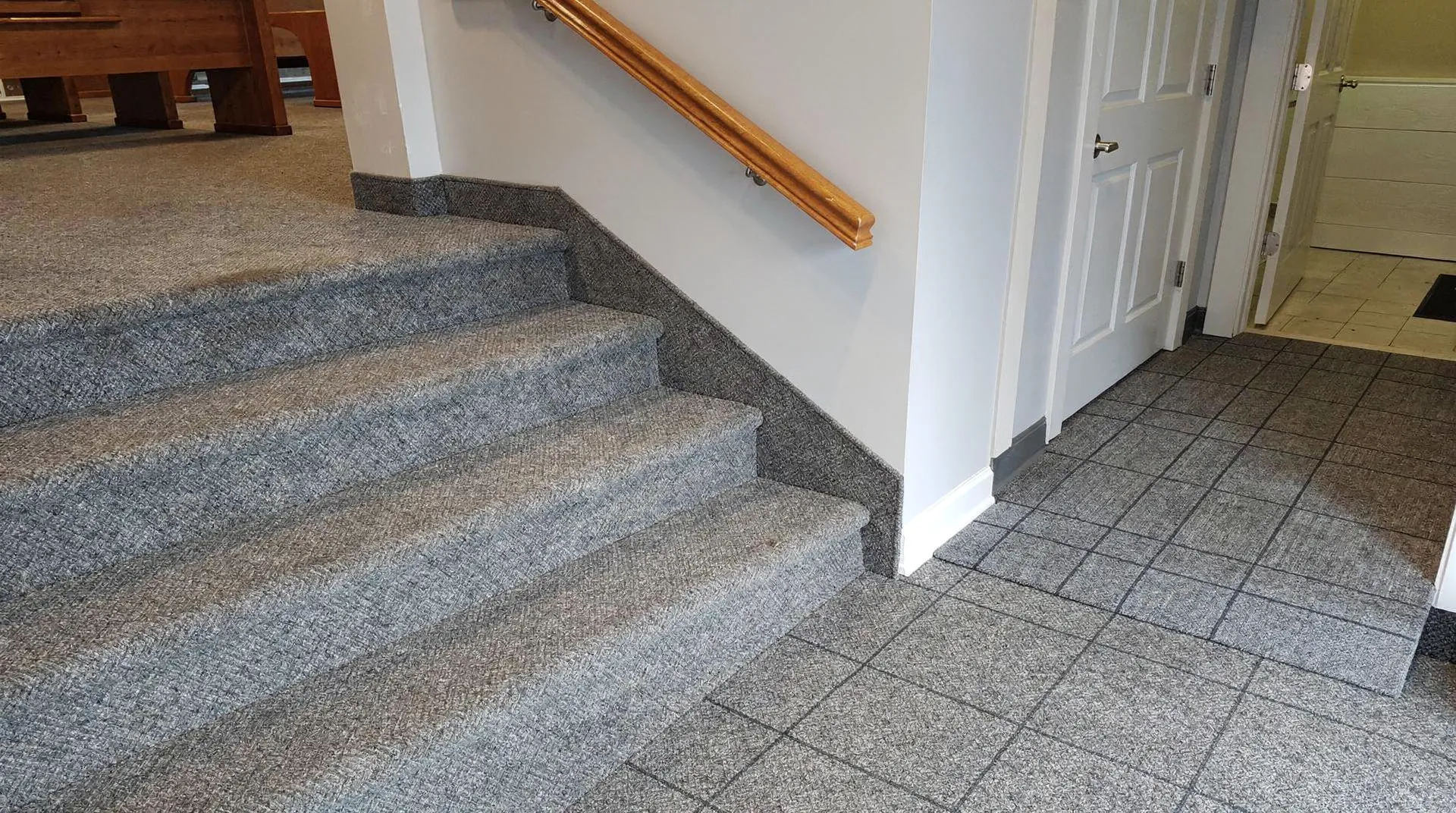 Durable loop-pile commercial carpet installation on stairs and flooring in a Connersville, Indiana business.